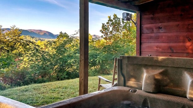 A hot tub with a view of a mountainous landscape. - Views I Firepit I Pool Table I Hot Tub I Sleeps 4 (Sevierville)