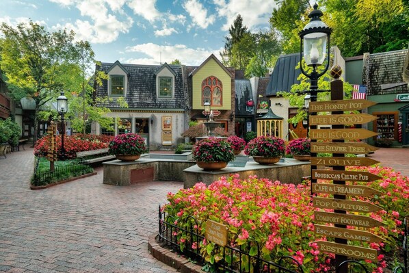 Explore the beautifully landscaped grounds, featuring vibrant flowers and a well-maintained brick pathway.