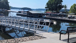A dock with boats, a wooden pier, and a bench. - 180 Degree Seneca Lake Views, privacy galore with hot tub. Sleeps 9
 (Senecaville)