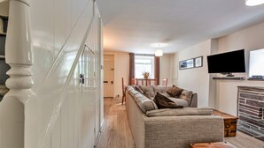 A living room with a sofa, a television, and a fireplace. - Blaen Ddol (Betws-Y-Coed)