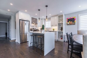 Enjoy cooking in this well-lit kitchen with a central island and stainless steel appliances.