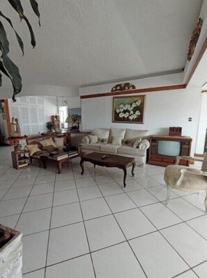 Relax in this inviting living room with a sofa, coffee table, and TV.