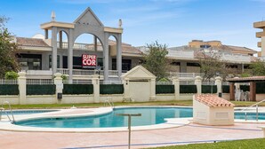 A hotel with a pool area, a Super Cor supermarket, and a well-maintained lawn. - Los Boliches Sunny Apartment - Ref 120 (Fuengirola)