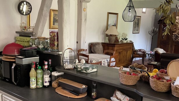 A kitchen with a black countertop, white cabinets, and a coffee maker. - Farmhouse in the heart of the Loire castles (VILLEMARDY)