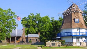 A windmill with a sign reading "TEX RITTER PARK" in front.
