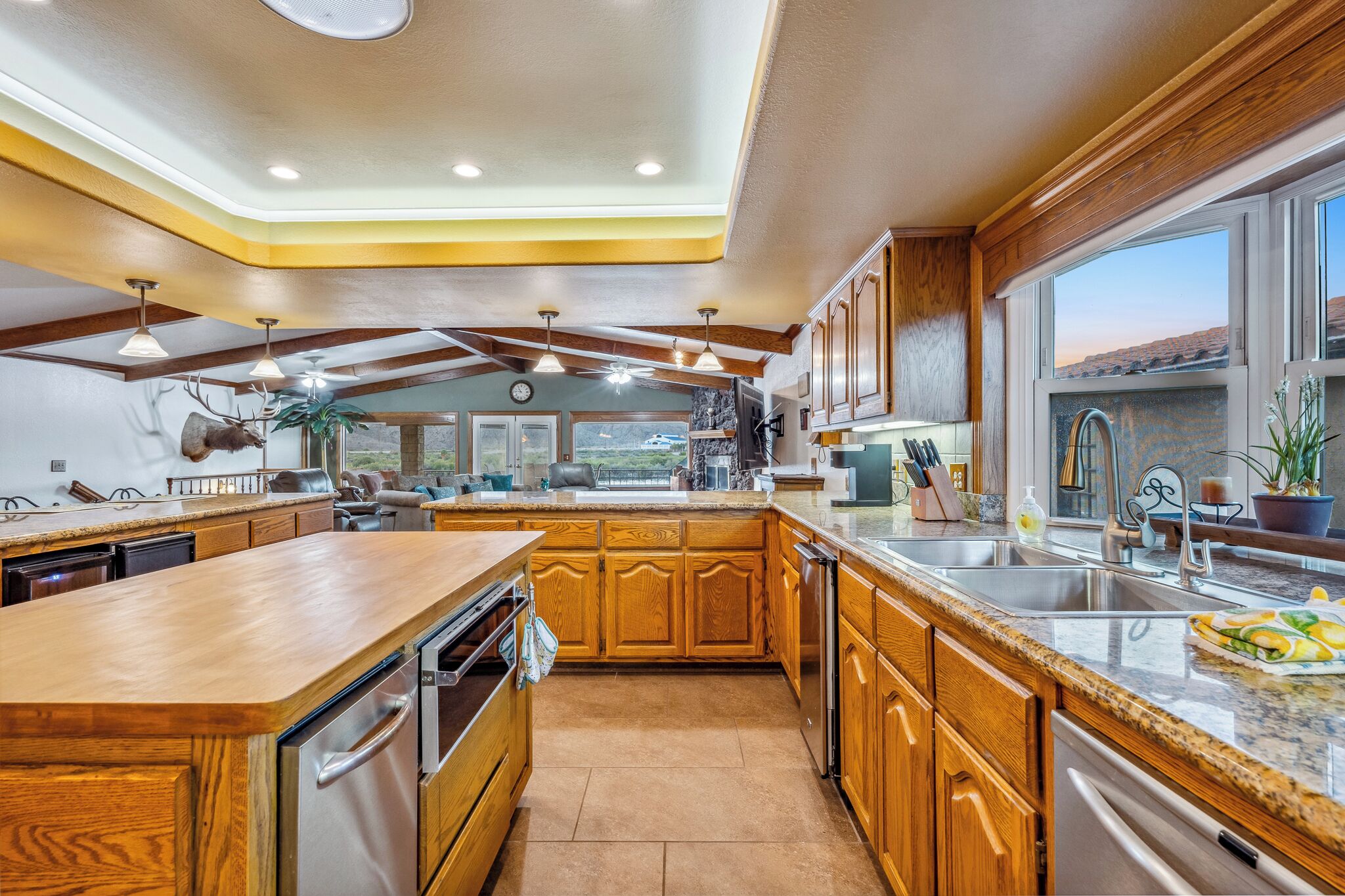 A spacious kitchen with wooden cabinets, stainless steel appliances, and a large island.
