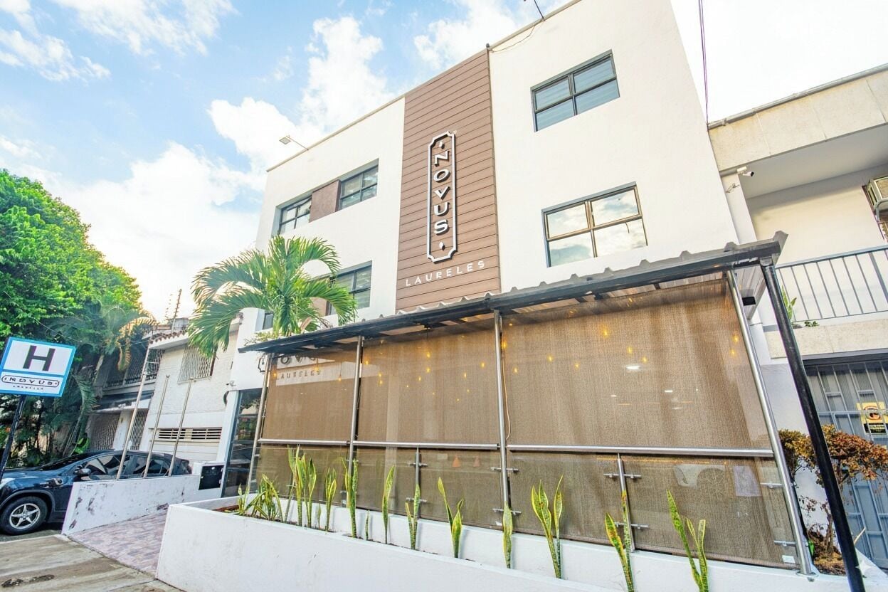 A modern building with a sign reading "NOVUS LAURELS."