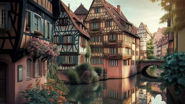 Une ville européenne traditionnelle, avec ses maisons à colombages, une rivière paisible et un pont.