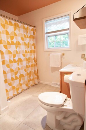 A bathroom with a toilet, sink, and window with blinds. - Technicolor River Retreat - Private get-away an hour outside of Chicago! (Lowell)