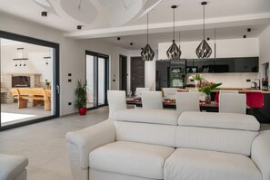 Relax in this stylish living space with a comfortable sofa and dining area.