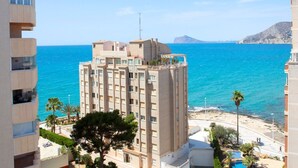 A high-rise hotel with balconies overlooking the sea, a pool area, and a view of the coastline. - Apartment 'La Reina' with Sea View, Wi-Fi and Air Conditioning (Calpe)
