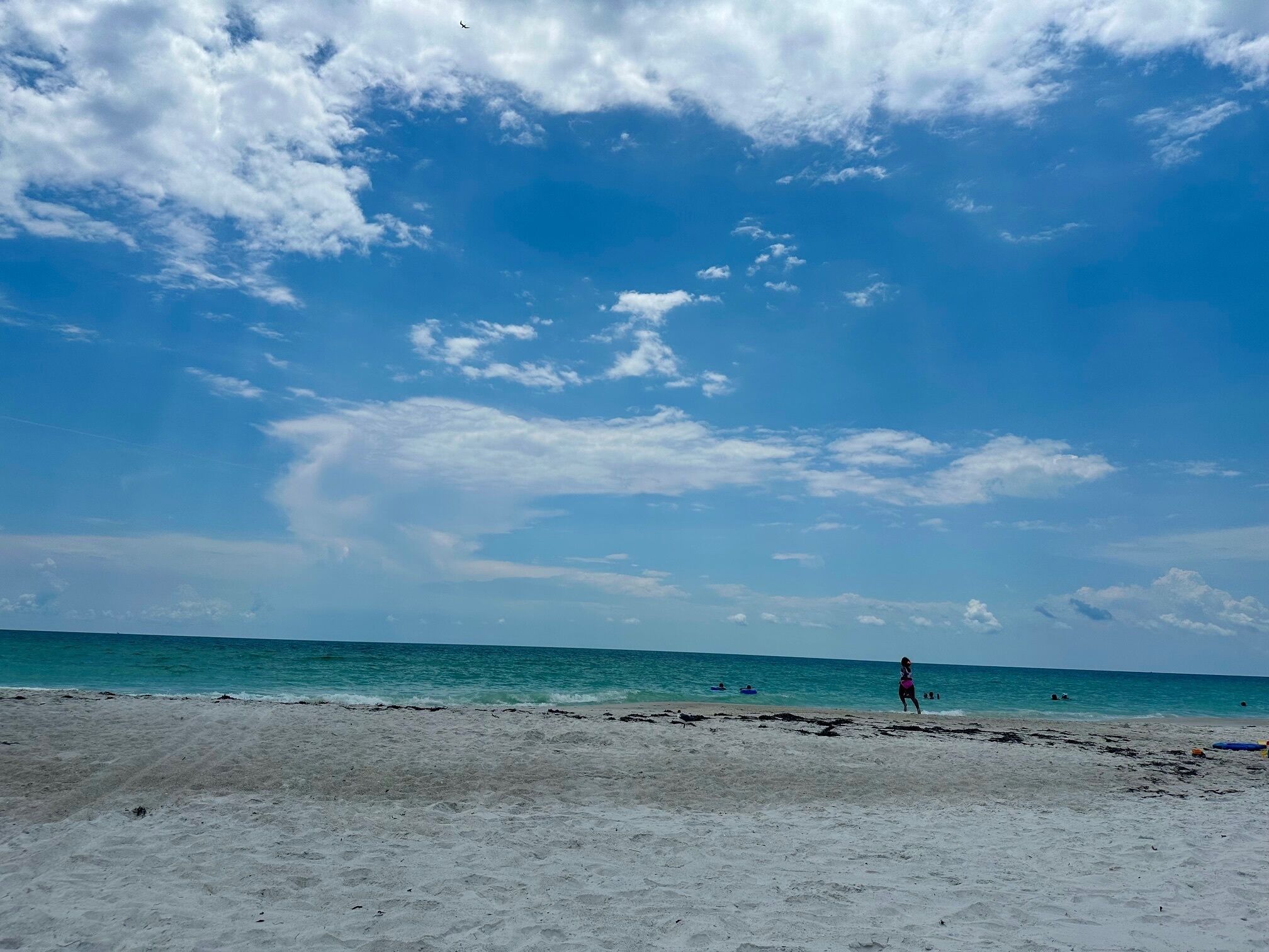 A beach with a clear sky and calm sea.