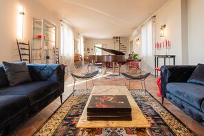 A living room with a piano, two sofas, a coffee table, and a patterned rug. - Holiday Home 'Umbriance Villa' with Private Pool (STRONCONE)