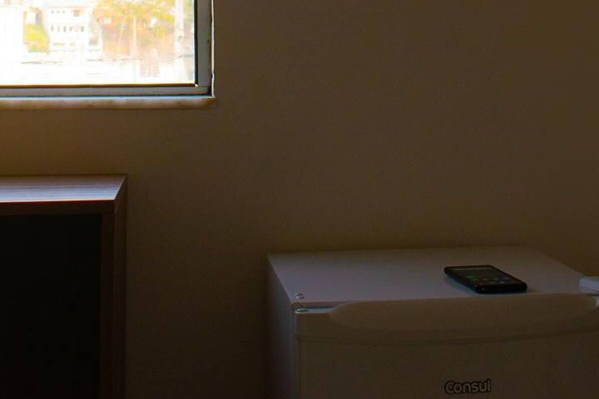A room with a white cabinet and a small table.