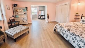 A bedroom with a bed, a vanity with a mirror, a dresser, and a bench. - Audrey- an ode to an icon (Salem)