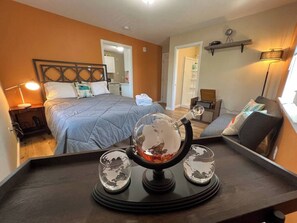 A hotel room with a bed, bedside table, lamp, and a decorative globe on a tray. - Two side-by-side apartments (Salem)