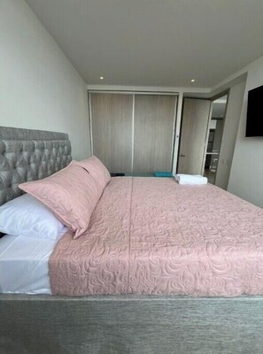 Relax in a stylish room with a comfortable bed, large wardrobe, and flat-screen TV.