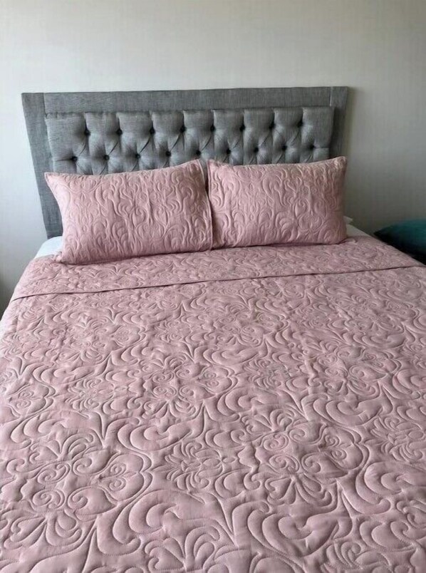 Classic comfort awaits in this elegantly appointed room with a tufted headboard and plush quilt.