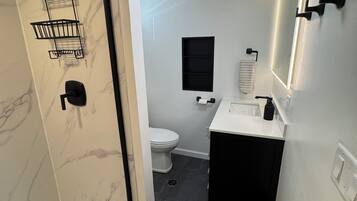 Shower, hair dryer, towels, toilet paper