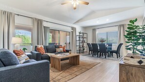 Un salon moderne avec un canapé, une table basse et un coin repas.