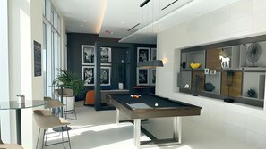 Enjoy social gatherings around the central pool table and relax in the comfortable seating area.