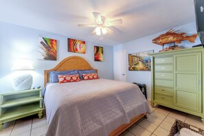 A bedroom with a bed, a ceiling fan, a green dresser, and wall art. - 108 1st Floor ! Waterfront !  Pool ! Hot ! Tub   (Corpus Christi)