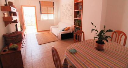 Apartment with pool near the beach and a park with sports facilities.