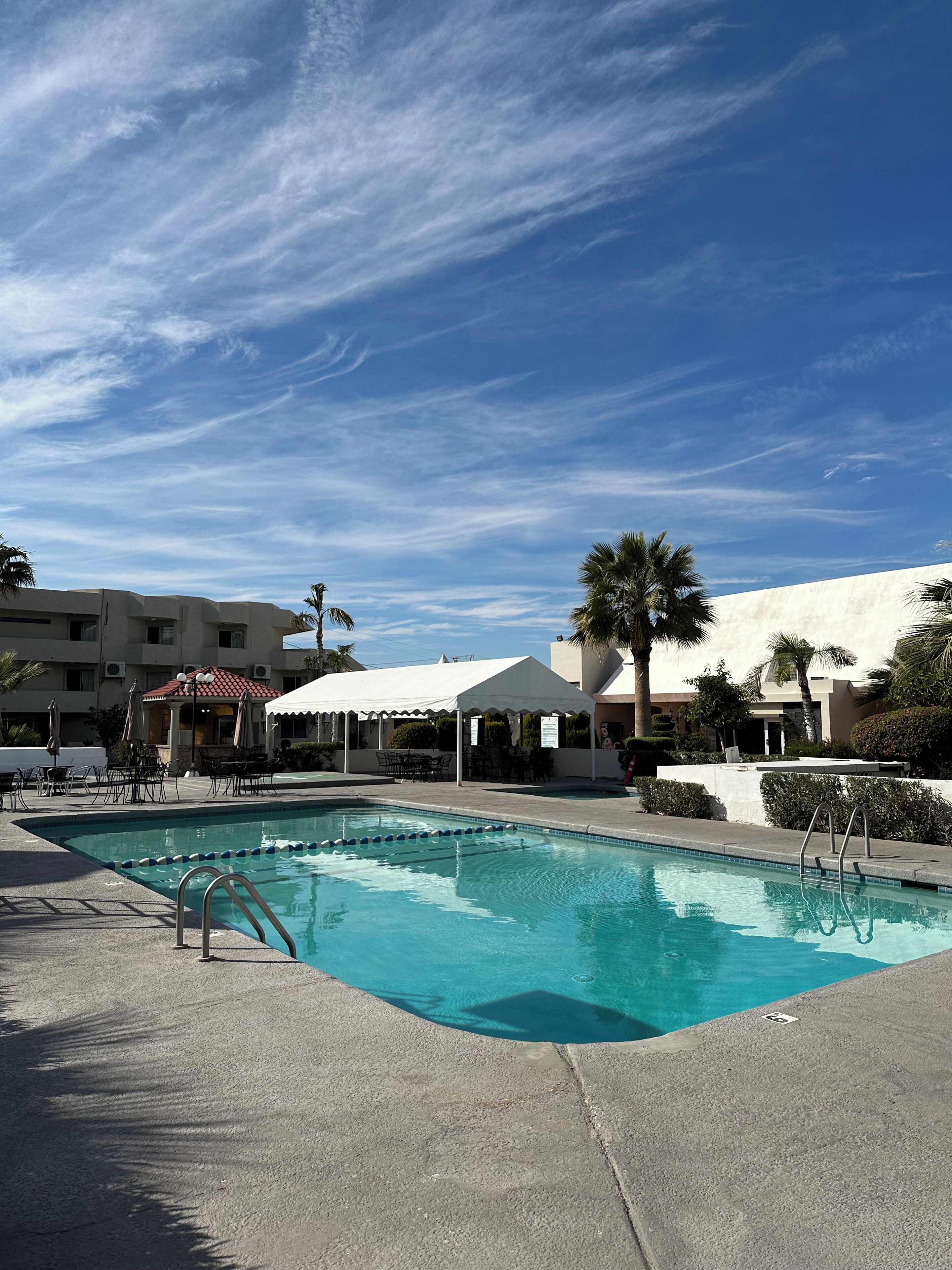 Outdoor pool, open 10:00 AM to 10:00 PM, pool umbrellas