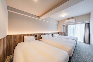 A hotel room with two beds, a wooden headboard, an air conditioning unit, and a window with curtains. - Apartment Hotel 11 Namba Minami (Osaka)