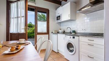 Fridge, microwave, coffee/tea maker, cookware/dishes/utensils