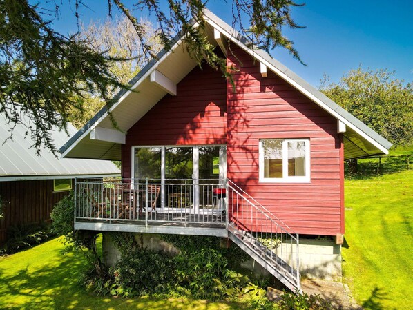 Relax on the spacious balcony with a view of lush greenery and a well-maintained lawn.