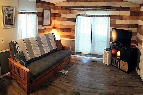 Living area of JC cottage with pull out bed, dvds and atari