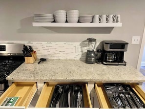 A kitchen with a granite countertop, a coffee maker, a blender, and a stove. - Beach Tower boardwalk walkout (Atlantic City)