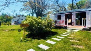 A white building with a porch and a sign indicating an office. - Skyline Terrace Cottages (Stanhope)