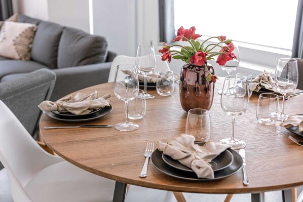 Enjoy a meal at this elegant dining table, complete with fine china and a beautiful centerpiece.