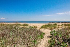 A beach with a clear sky, sandy dunes, and a calm sea. - Sojourn Isle Suite 2 BR 2 BA at Beach Cottages (Norfolk)