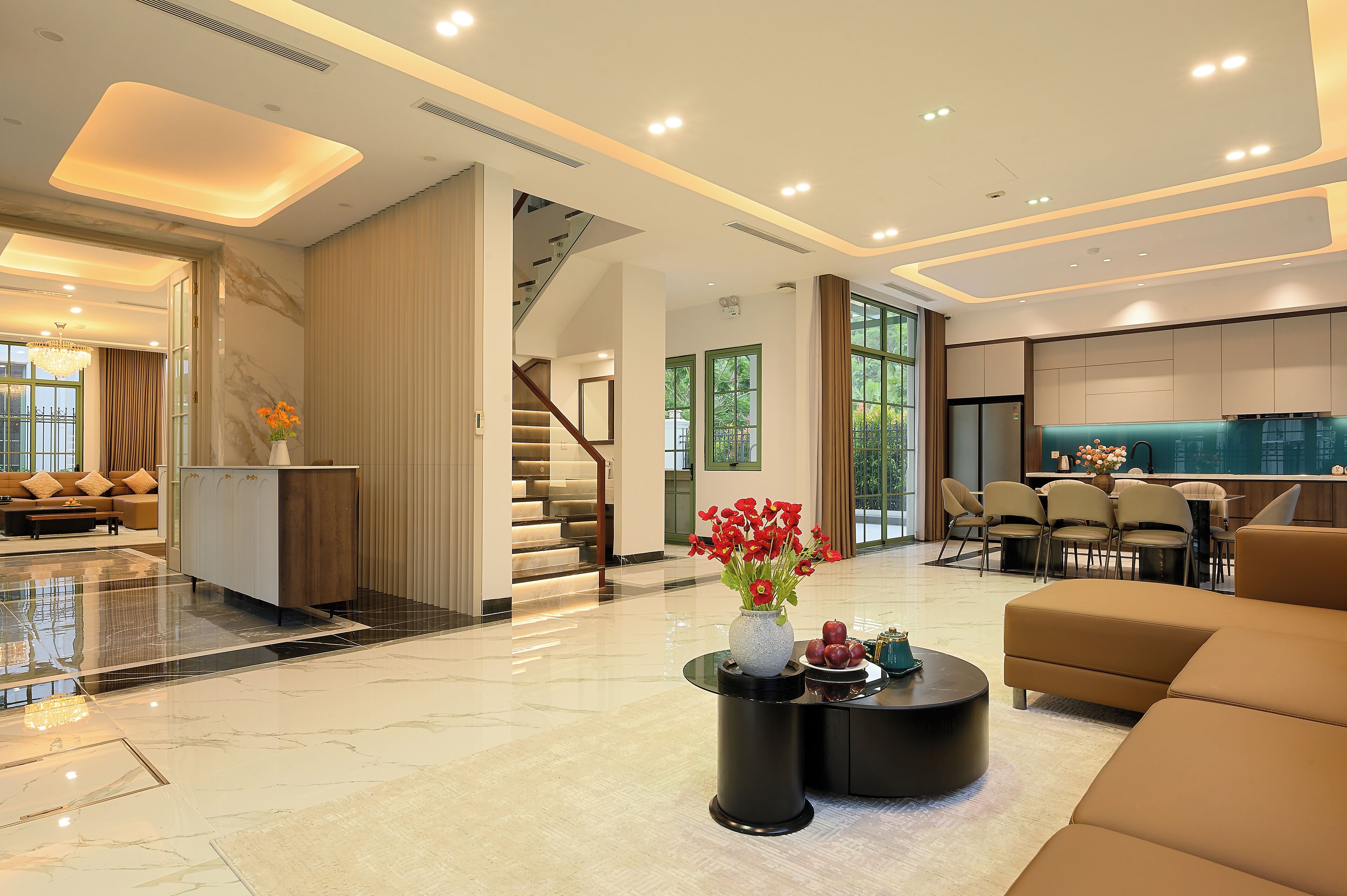 A modern hotel lobby with a marble floor, a staircase, a dining area, and a sofa.