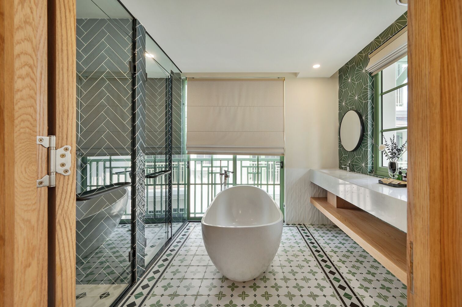 A modern bathroom with a freestanding bathtub, a glass shower enclosure, and a vanity with a mirror.