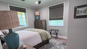 A bedroom with a bed, a nightstand, a lamp, a ceiling fan, and a window with blinds. - Cozy Waterfront Retreat at McMichael Farms (Chesterfield)