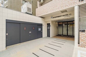 A hotel entrance with a sign for 'Apartment Hotel II Dotonbori II'. There are two doors, one with a 'KEEP OUT' sign and another with a 'No Entry' sign. - Apartment Hotel 11 Dotonbori II (Osaka)