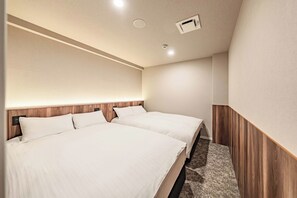 A hotel room with two beds, a wooden headboard, a carpeted floor, and a ceiling with recessed lighting. - Apartment Hotel 11 Dotonbori II (Osaka)