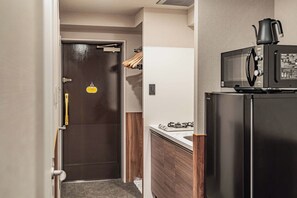 A kitchen with a microwave, stove, and refrigerator. - Apartment Hotel 11 Dotonbori II (Osaka)