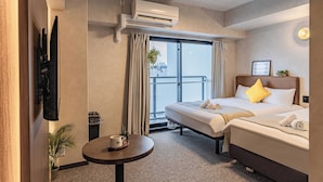 A hotel room with a bed, a small table with a cup, a plant, and an air conditioning unit. - Apartment Hotel 11 Kuromon II (Osaka)