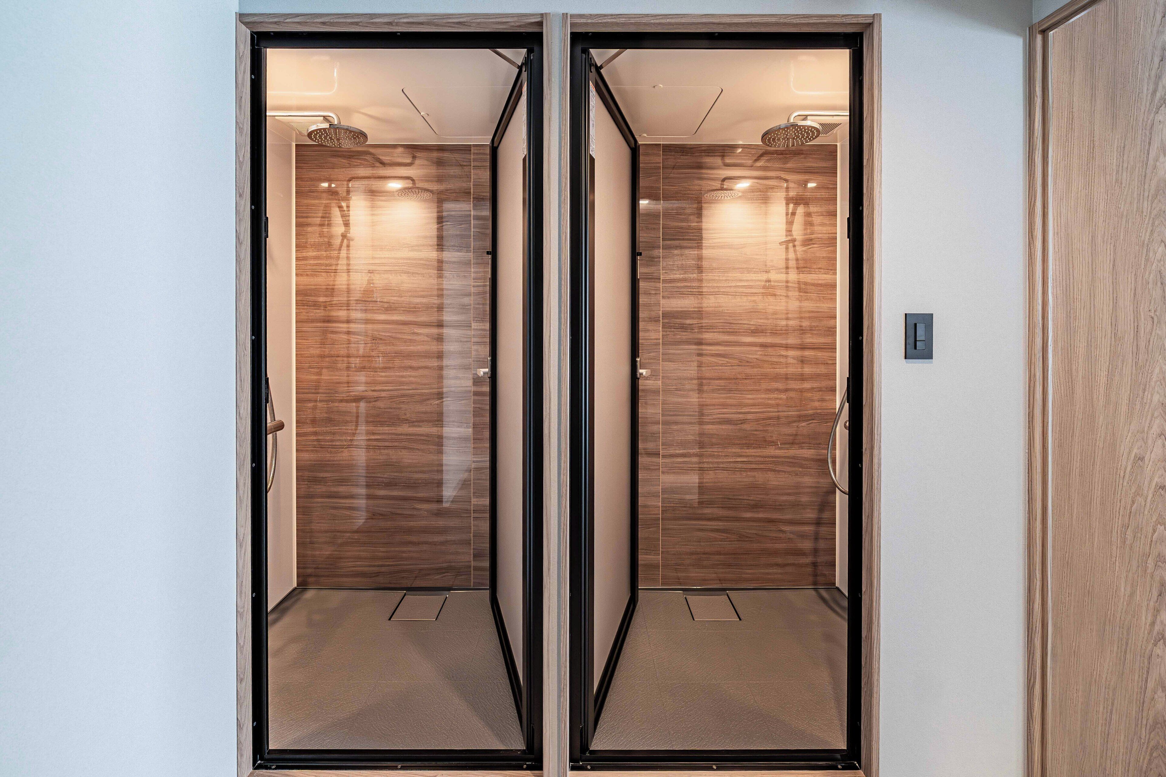 A mirrored closet with a wooden finish and a metallic frame.