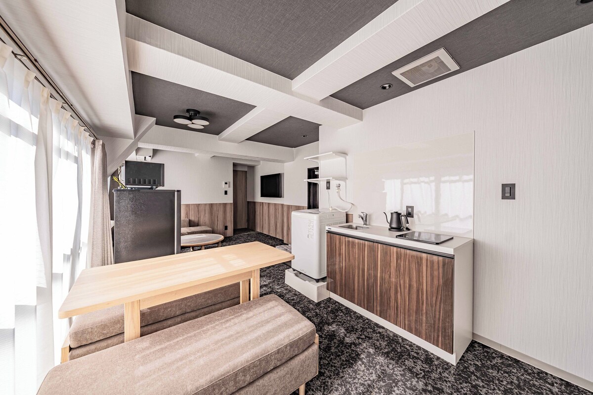 A modern kitchen with a built-in oven, a sink, and a countertop.