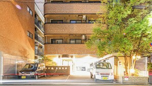 A multi-story building with a brick facade and balconies. - Apartment Hotel 11 Shinsaibashi 5 (Osaka)
