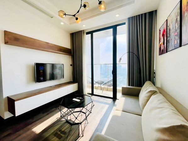 Luxury Apartment, 3 Bedrooms, Private Bathroom, City View | Living area | 60-inch flat-screen TV with cable channels, pay movies - MC Homes - Vinhomes Skylake Apartment (Hanoi)