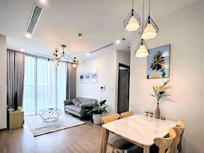 Luxury Apartment, 2 Bedrooms, Private Bathroom, City View | Living area | 60-inch flat-screen TV with cable channels, pay films - MC Homes - Vinhomes Skylake Apartment (Hanoi)