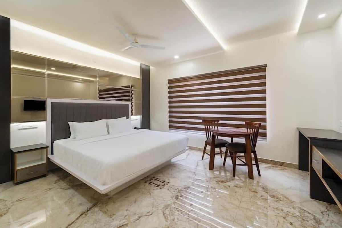 A modern bedroom with a bed, a desk, and a chair.
