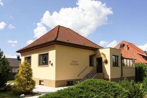 Stunning Haus Yvonne features a charming facade, a red-tiled roof, and a welcoming entrance.